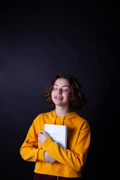 Young caucasian girl holding notebook with Back to School — Stock Photo, Image