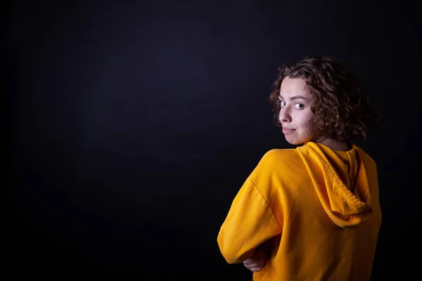 Young caucasian highschool girl in yellow hoodie posing in the studio — Stock Photo, Image