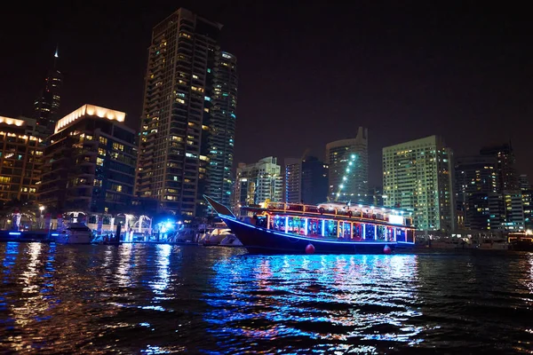 Dubai Marina at night with colorful touristic boats — Stock Photo, Image