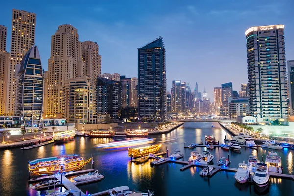 Dubai marina with boats and buildings with gates at night — Stock Photo, Image