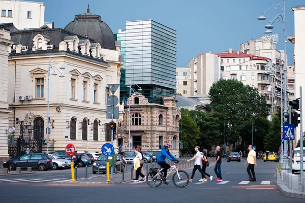 Ciclista e persone che attraversano la strada — Foto Stock