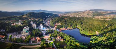 Aerial panoramic drone shot of Sovata city with Ursu Lake clipart