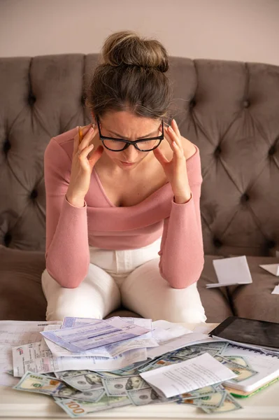 Stressed Woman counting money at home. Investment opportunities, payrolls, bills budget