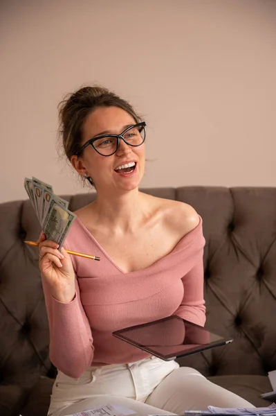 Happy Woman counting money at home. Investment opportunities, budget planning and future finance