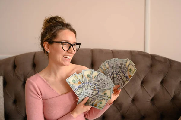 Happy Woman counting money at home. Investment opportunities, budget planning and future finance
