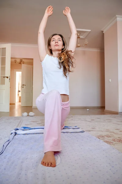 Woman doing physical exercises at home during quarantine