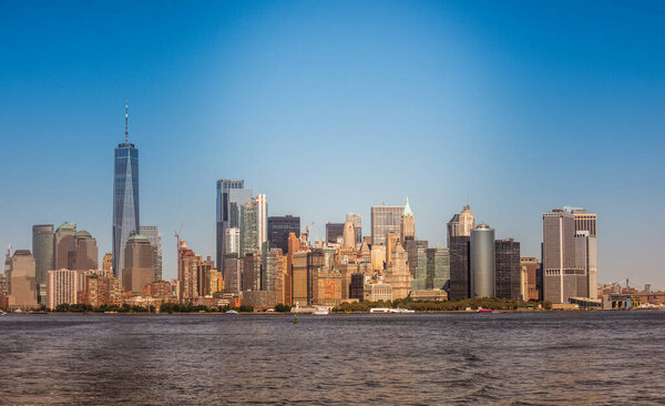 View of Manhattan from the water, multiple high buildings in New York, USA. Vibrant colors