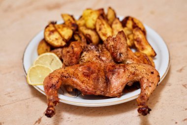 Patatesli fırında tavuk ve limon dilimleri.