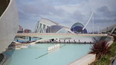 Valencia, Spain - May 28, 2025: White Palau de les Arts letters floating on the pool with the building's sweeping forms behind