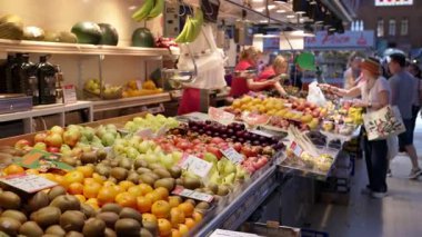 Valencia, Spain - May 21, 2025: Neat rows of pears, kiwis, and oranges with simple price tags at an indoor market