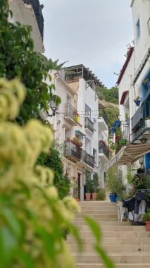 Charming narrow street with multiple steps in Benidorm Old Town, Spain. Vertical