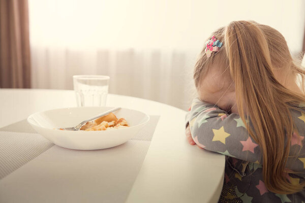 Little girl refuses to eat. Child meal difficultes theme.