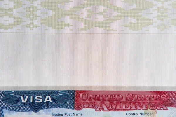 USA visa in passport close-up. Passport with visa of United States of America and blank page.