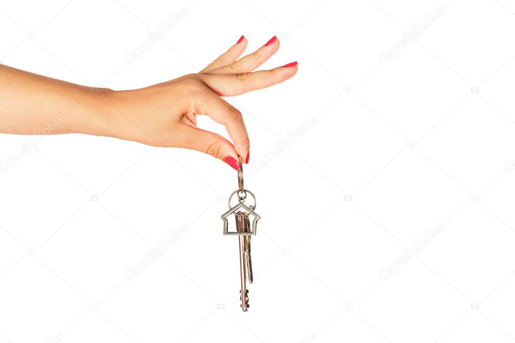Woman hand holding keys isolated on white background. Real estate sale concept.