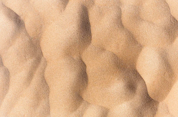 Sand texture. Sand waves patterns view from above. Sandy background.