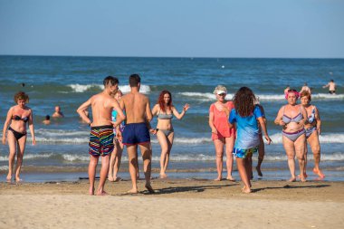 Rimini, İtalya - 13 Haziran 2018: Grup üst düzey insan denizi sahilinde yaz güneşli günde dans. Rimini, İtalya.
