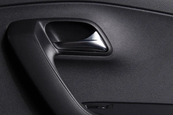 Car door handle inside. Clean car interior. Background for car cleaning themes.