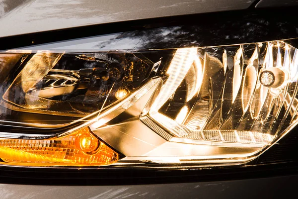 Car headlight on closeup. Polisher car headlamp.