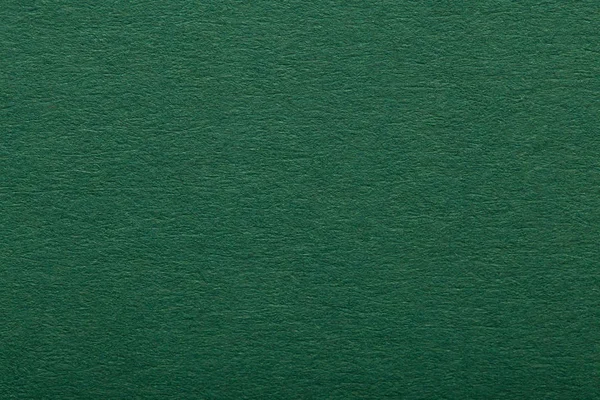 Dark green paper texture or background. Blank dark green page.