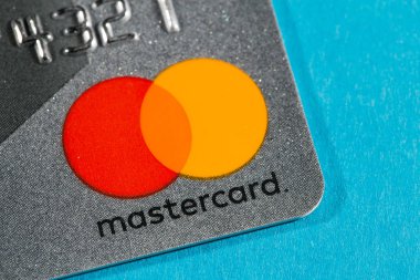 New York, USA - February 17, 2019: Credit master card close-up. Master card on blue background. clipart