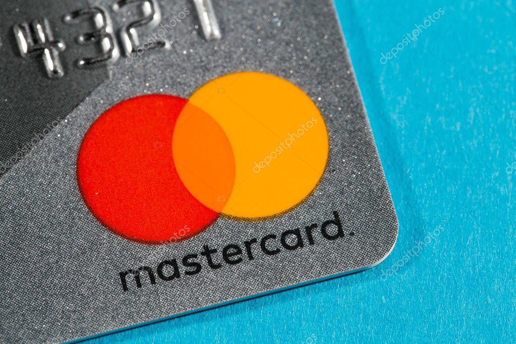 New York, USA - February 17, 2019: Credit master card close-up. Master card on blue background.