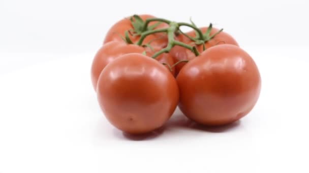 Five Red Tomatoes Held Together Vine Spinning White Platform — Stock Video