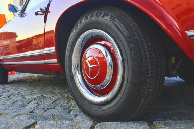 Mercedes Benz logo eski model araba tekerlek üzerinde. Mercedes-Benz Alman otomobil üreticisidir. Marka lüks otomobiller, otobüsler, antrenörler ve kamyonlar için kullanılır. 