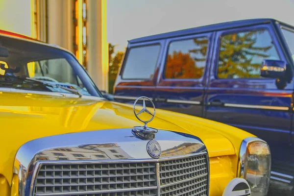 Logo de Mercedes Benz en un coche vintage amarillo. Mercedes-Benz es un fabricante de automóviles alemán. La marca se utiliza para automóviles de lujo, autobuses, autocares y camiones . —  Fotos de Stock