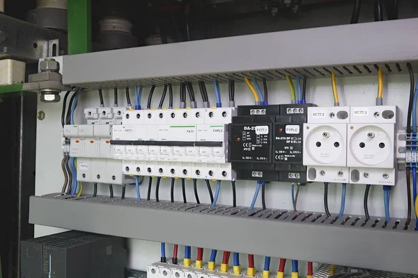Image shows control cubicle. Electric device and circuit breakers inside power case.