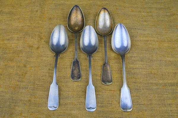 Old spoons on a bagging background. Five vintage spoons. Top view. Free space for text — Stock Photo, Image