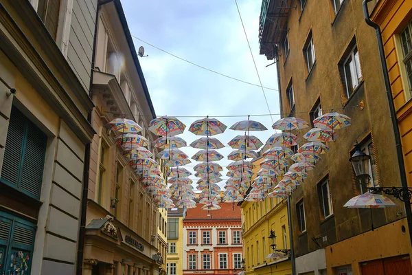 Umbrellas above the street in Bratislavas Old Town district. Colorful umbrellas hanging out above the old streets — Stock Image Umbrellas above the street in Bratislavas Old Town district. Colorful umbrellas hanging out above the old streets Royalty Free Stock Images