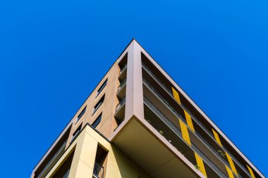 Değişik apartman binaları, balkonları ve parlak mavi gökyüzü altında kentsel tasarımı olan modern yerleşim yerleri..