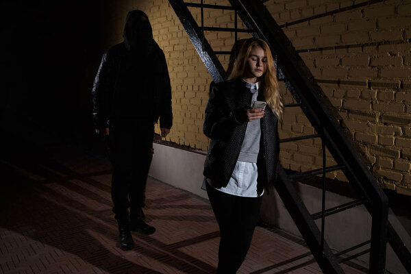 crime concepts robbery concepts a robber aimed his sharp knife at a woman to rob her valuable things in bag