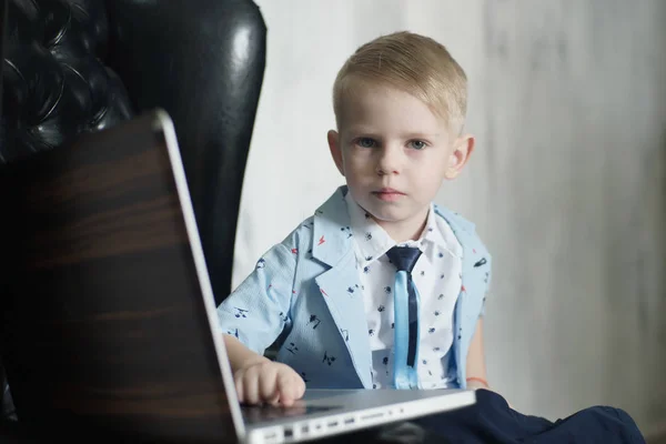 Jongen met behulp van een laptop. Beeld kruis verwerkt voor donkerder effect — Stockfoto