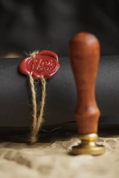 Tied scroll with old notarial wax seal and stamp on table — Stock Photo, Image