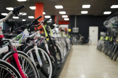 Bulanık görüntü çocuk birden çok satır üzerinde asılı bisiklet raf Humble, Texas, mağazada, bize. Çeşitli parlak renkli bisiklet çocuk bisikleti dükkanda için. Aktif yaşam tarzı kavramı arka plan, vintage sesi