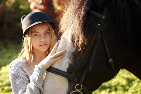 Beautiful young girl jockey talks with her horse dressing uniform competition — Stock Photo, Image