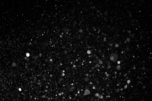 Textura bokeh nieve sobre fondo negro — Foto de Stock