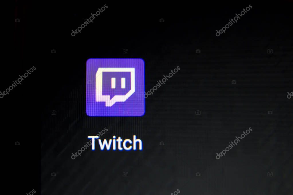 Tula, Russia - October 31, 2018:: A Man holds edge Mobile Phone with Twitch application on the screen in coffee shop. Twitch is a live streaming video service