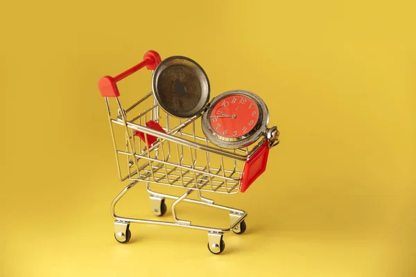 Red clock on the shopping cart, lack of , waste of time, purchasing , Business concept.
