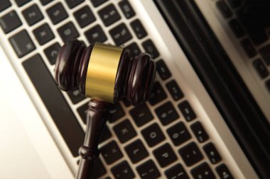 Online auction concept. Auction or judge gavel on a computer keyboard. Judge hammer on laptop clipart