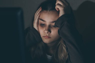 Internet siber zorbalık acı genç kız korkmuş ve cyberbullying depresif. Umutsuzluk kız humilated sınıf arkadaşı tarafından Internet üzerinde görüntü. Belgili tanımlık laptop önünde ağlıyor genç Genç kız