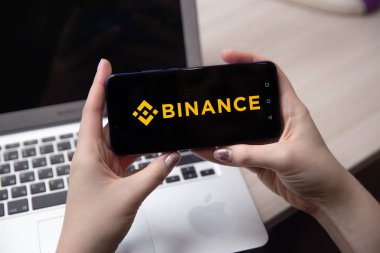 Tula, Rusya - 28 Kasım 2018: Apple iphone ve Binance logo ve bitcoin, ethereum ve dolar. bir cryptocurrency değişimi.