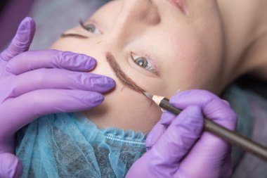 Makyaj güzel kadının güzellik salonu içinde kalın kaşları ile kaşları için. Dövme kaş yaparken tatlı Şevval özçelik güzellik.