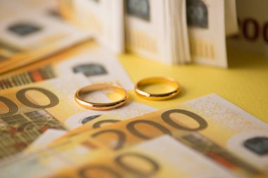 Altın alyans banknotların arka plan üzerinde. Evlilik