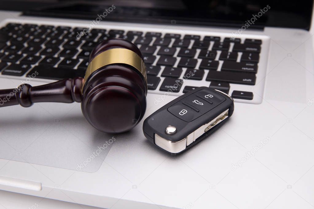 Judge gavel on laptop keyboard. Symbol of law, justice and online auction