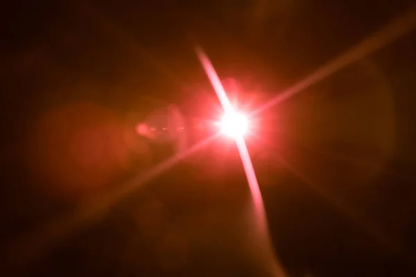 Abstract lens flare red light over black — Stock Photo, Image