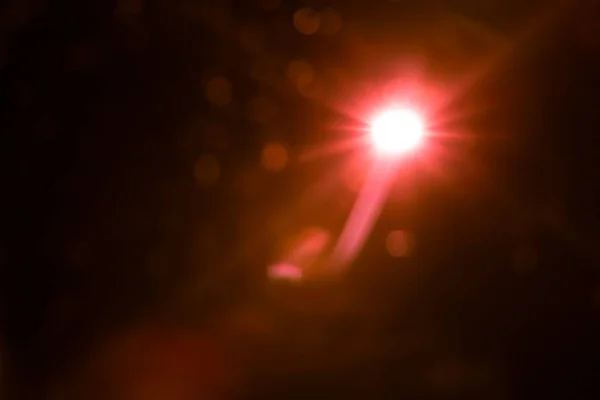 Abstract lens flare red light over black — Stock Photo, Image