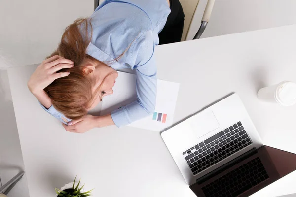 Joven chica de oficina sentada en su lugar de trabajo sintiéndose mal. La mujer tiene dolor de cabeza. . — Foto de Stock