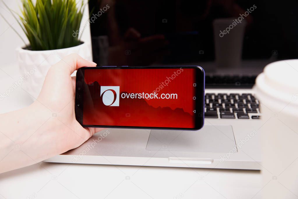 Tula, Russia - February 18, 2019: Overstock logo on smartphone